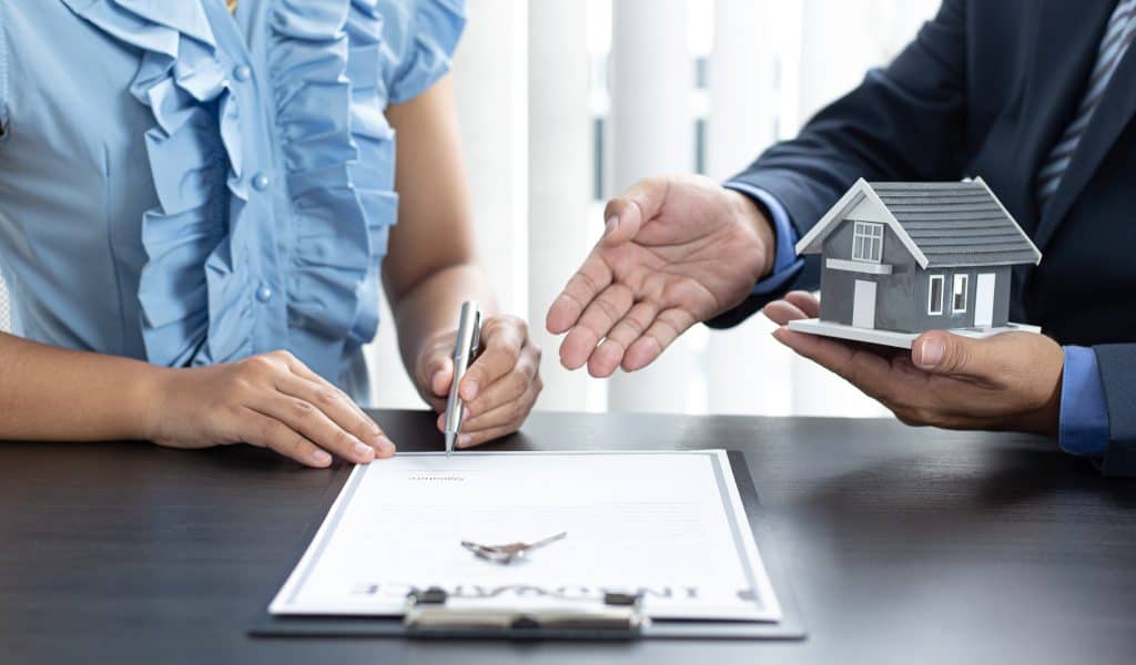 Expat signing mortgage agreement for Dubai property purchase with expert guidance